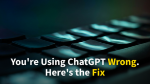 Overhead view of hands typing on a green-glowing laptop in a dark room