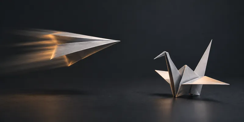 A paper aeroplane blurred in flight on the left and a perfectly sharp origami crane standing still on the right, on a dark studio background